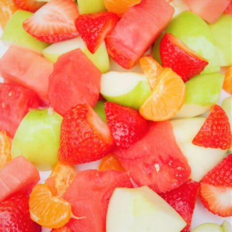 Close up of a fruit salad consisting of watermelon, strawberries, apple, and nectarine.