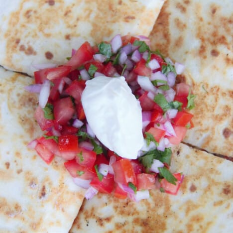 Pico de Gallo is topped on quesadillas as a refreshing condiment.