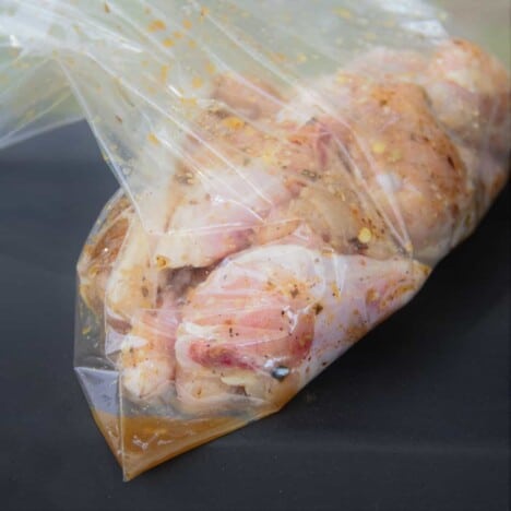 Chicken wings marinating in a plastic bag.