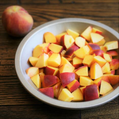 Cut peaches in a metal pie pan.