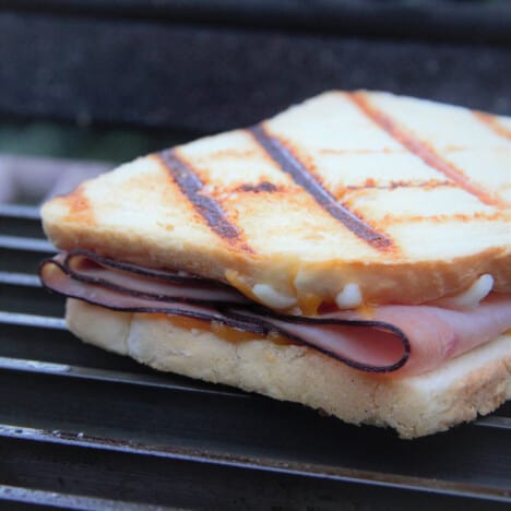 Close up image of a grilled ham and cheese sandwich