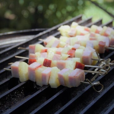 Ham and pineapple kebabs just being put on the grill to heat through.