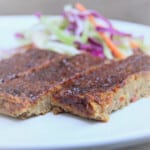 Three pieces of Chickpea loaf are served with a slaw.