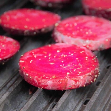 Bright red sliced beets on the grill.