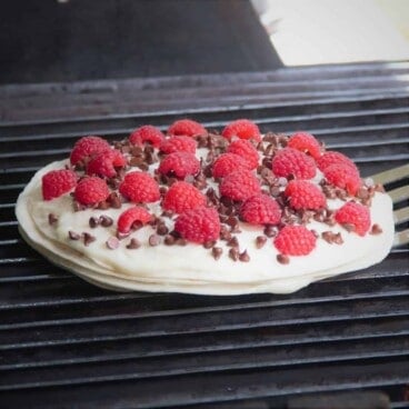 A chocolate raspberry quesadilla cooks on a grill.