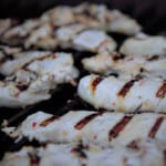 Chicken tenders with deep hatch marks on the grill.