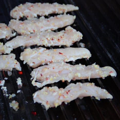 Marinated chicken tenders on the grill.