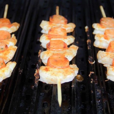 Shrimp and smoked sausages sitting evenly and parallel to the GrillGrates