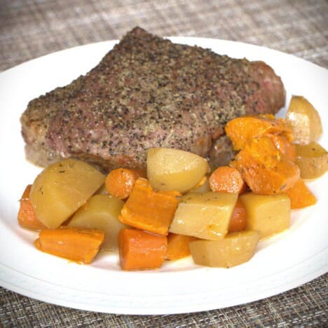 A serving plate with the cooked corned beef and vegetables.