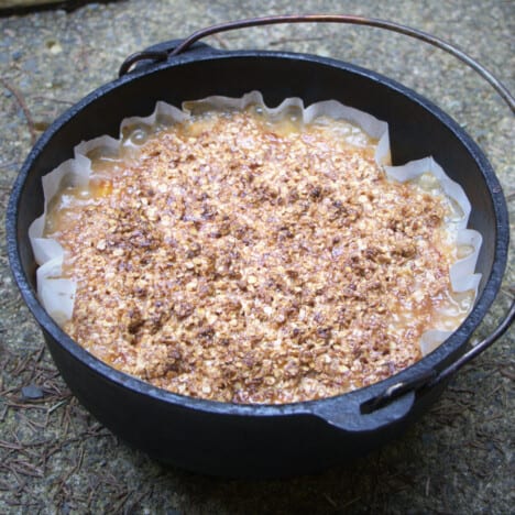 A full Dutch oven seeing it lined with paper and the top of a crisp.
