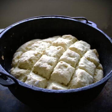 A Dutch oven with grid formed baked ginger beer scones in it.