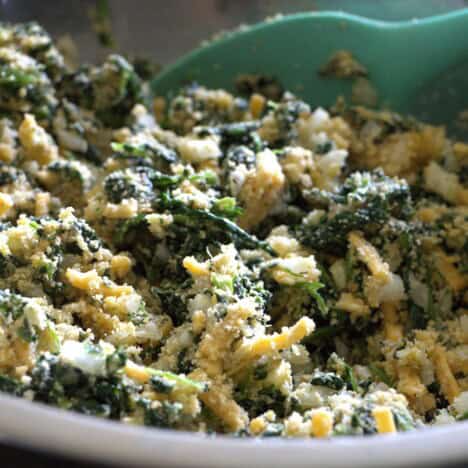 All the spinach patty ingredients loosely combined in a stainless bowl.