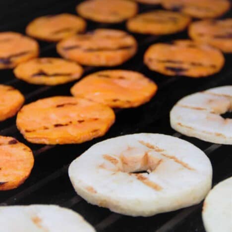Slices of apples and sweet potatoes with hatch marks on the grill.