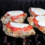 Grillgrates with finished grilled chicken parma ready to serve.