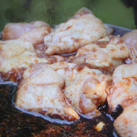 Raw chicken drumettes sitting in marinade.