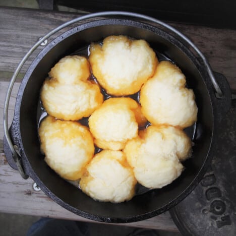 Ariel view down on cooked Golden Syrup Dumplings still in the Dutch oven they were cooked in.