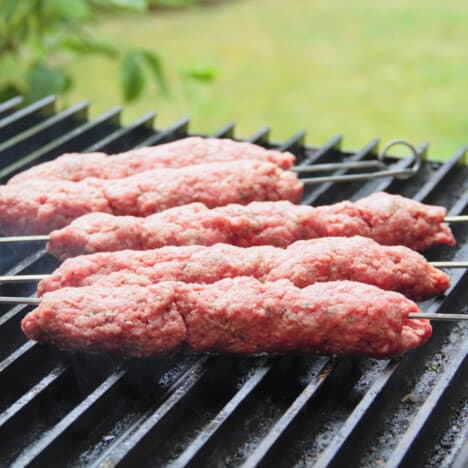 Grilled Beef Kebabs have just been placed on the grill.