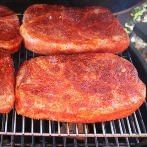 Grilled Pork Butt Steaks just rubbed and placed on the grill.
