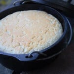 An arial shot of a baked beer bread in a Dutch oven.