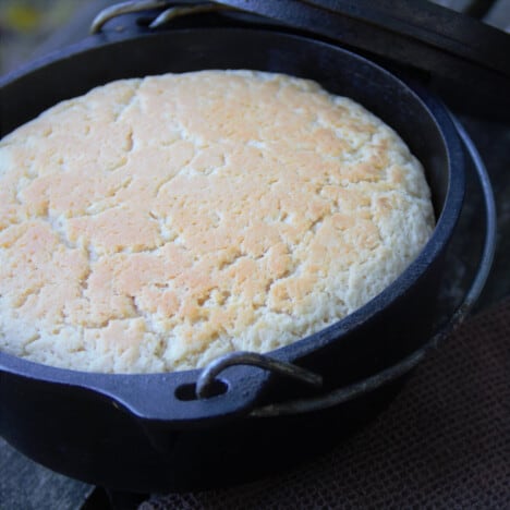 An arial shot of a baked beer bread in a Dutch oven.
