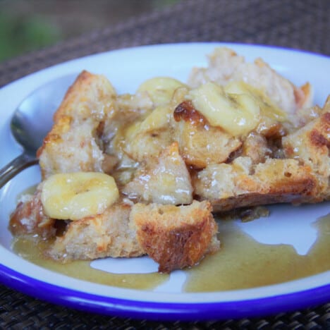 A serving of the banana bread pudding topped with the banana sauce.