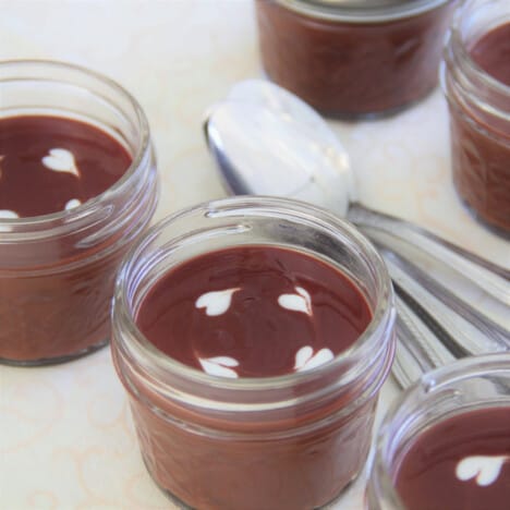 Chocolate cups laid out to eat with spoons.