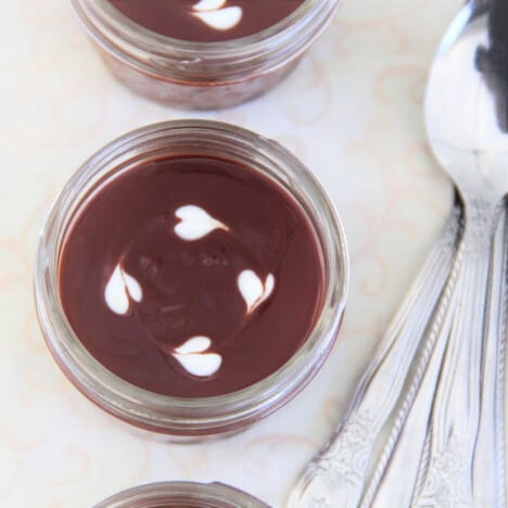 Looking down on a completed chocolate pot with four cream hearts for garnish.