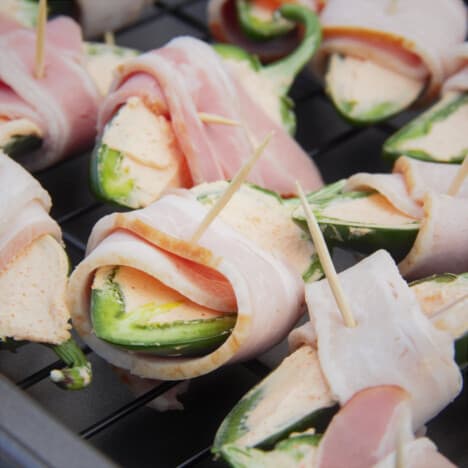 Raw jalapeño poppers prepared and laid out waiting to be cooked.