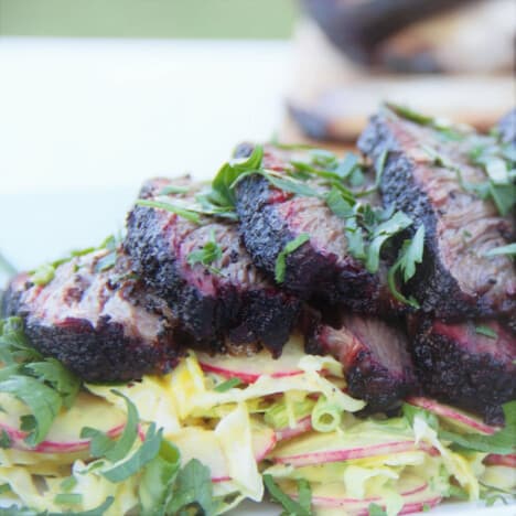 Slices of beef ribs laid out on a salad.
