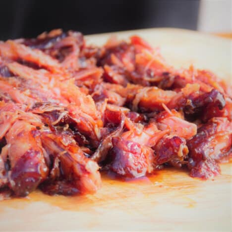 Close up on a pile of pulled pork from the ribs.