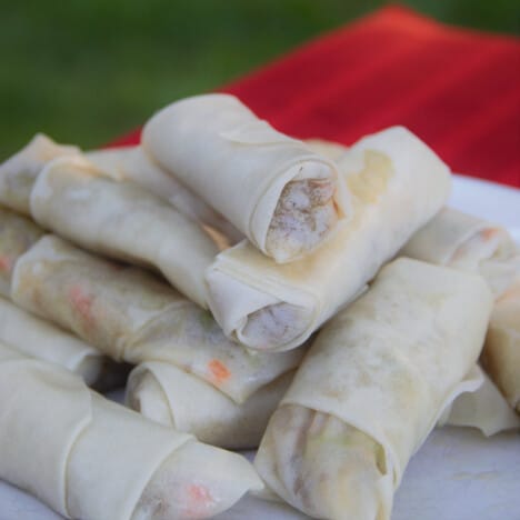 A pile of fresh spring rolls waiting to be fried.