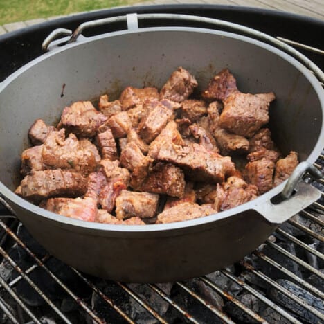 Asian braised beef cooking in a Dutch oven.