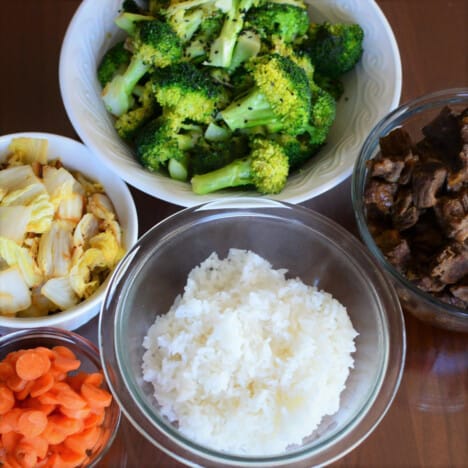 The elements for the Korean-inspired Beef Bowl laid out on a bench in bowls.
