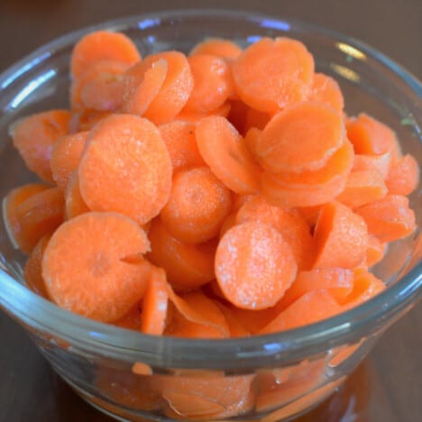 A bowl of carrot coins in a glass bowl.