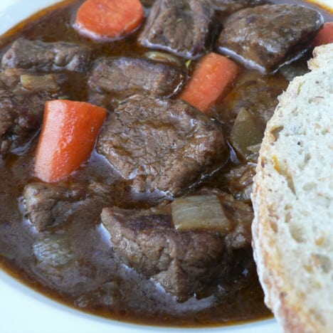 A bowl of Beef and Guinness Stew with chunks of carrots and celery.