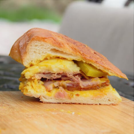 A halved smoked Cuban sandwich is exposing it delightful fillings.