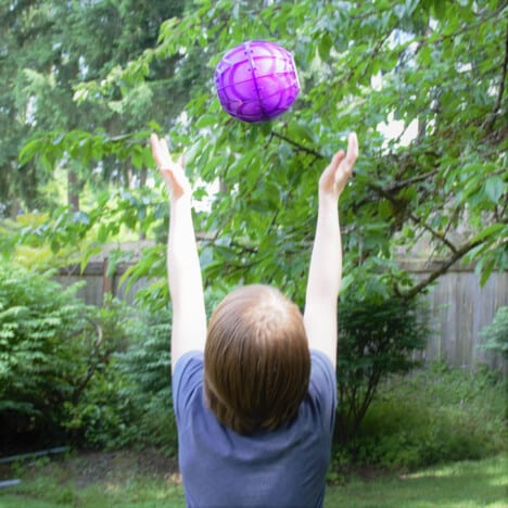 A novelty ice cream ball is being tossed into the air to keep the cream mixture moving as it freezes.