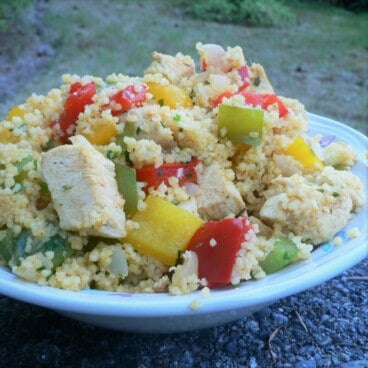 A plate of the Chicken and Bell Pepper Couscous using red, yellow, and green bell peppers.