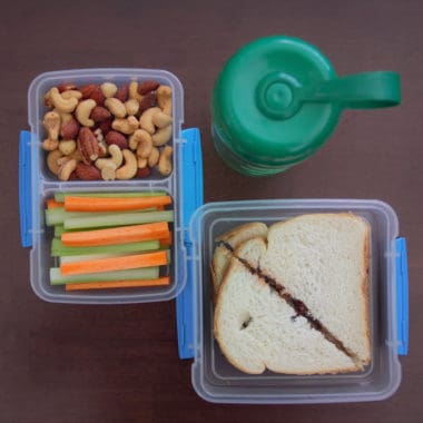 Areal photo of two lunch boxes and a drink.
