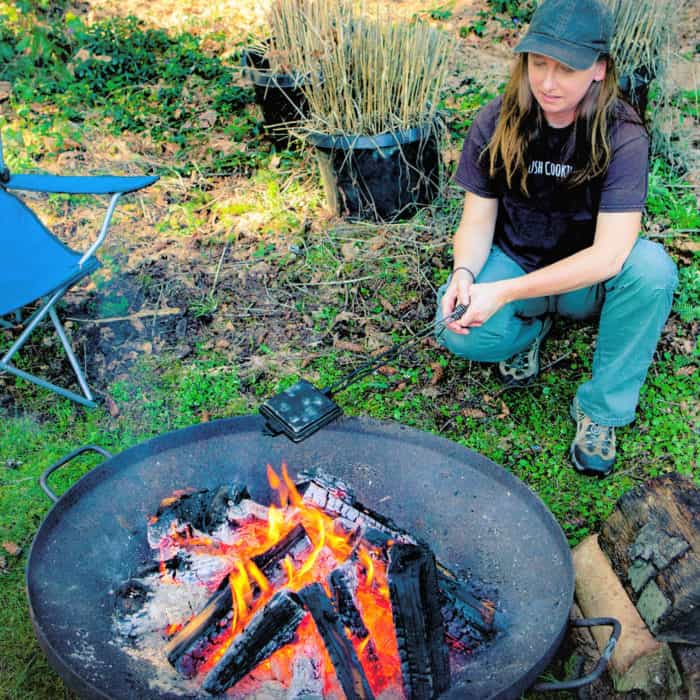 Saffon Hodgson Cooking in a pie Iron over a Campfire