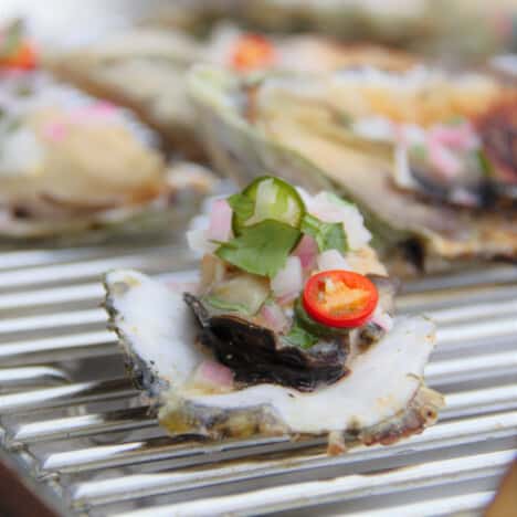 Close up of a finished Grilled Mexican Oyster sitting on a grill rack.