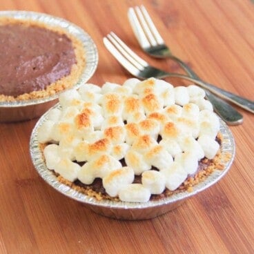 Two camp smore tarts one with brown marshmallows, the other yet to have the marshmallows added.