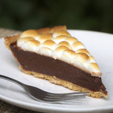A slice of smore tart served on a white plate.