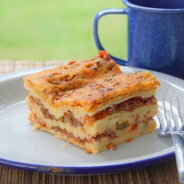 A chilled then reheated slice of lasagna with clean straight edges and visible layers.