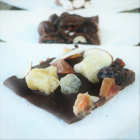A square of trail mix chocolate bark on baking paper.