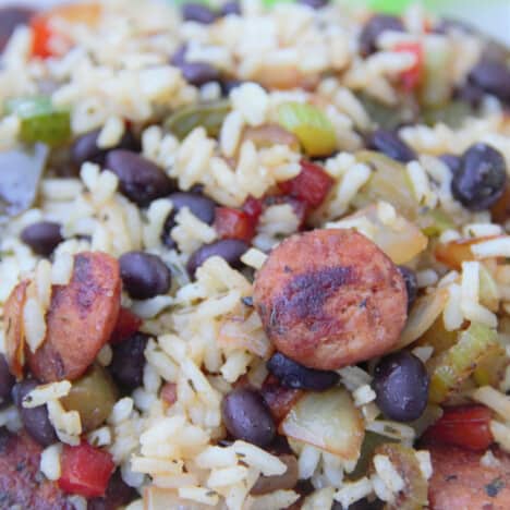 Close up of a finished Smoked Sausage and Black Bean Rice showcasing the variety of ingredients including the sausage, black beans, and vegetables in the rice.