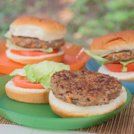 Three finish nangari burger patties served in basic burger with lettuce and tomato.