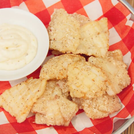 Looking down on a serving of salt and pepper squid with a tartar sauce accompaniment.