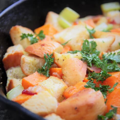 A close up of cooked butternut squash and bacon stuffing.