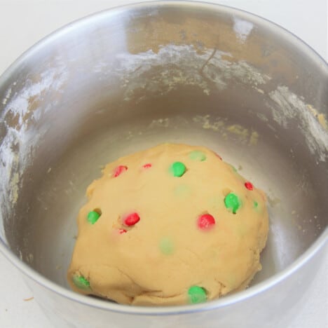 A ball of Christmas cookie dough in a signal large ball in a mixing bowl ready to be divided into small cookie sizes.
